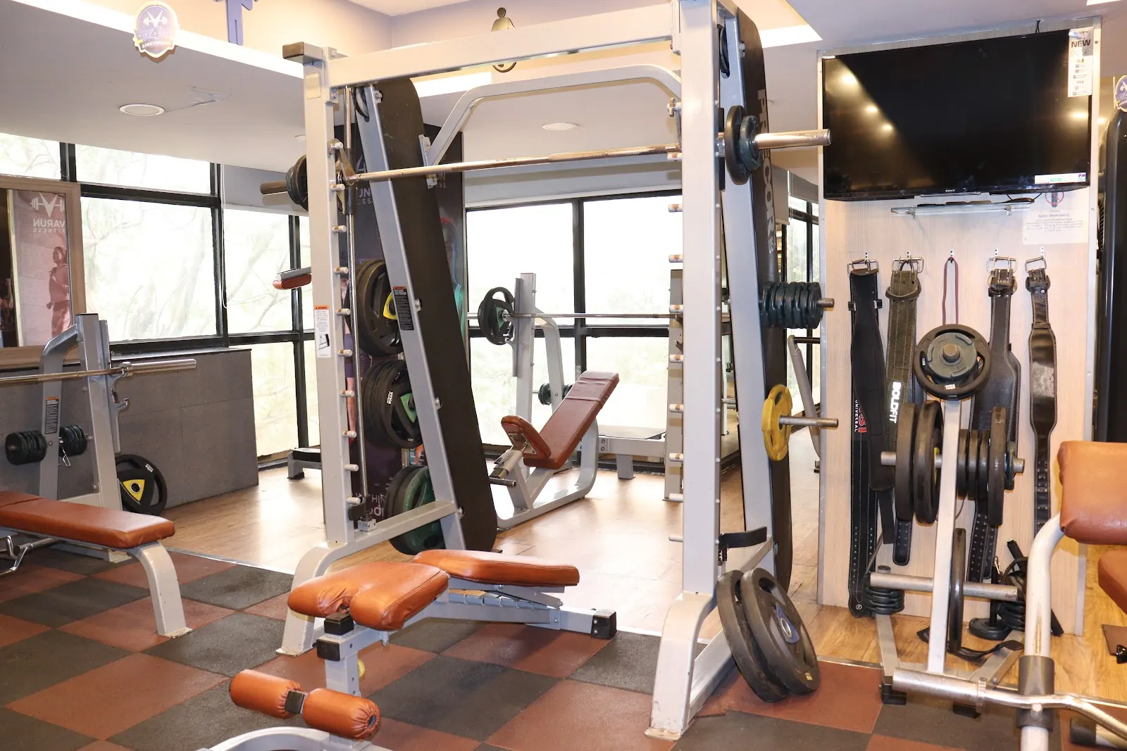 Smith machine and adjustable benches on a rubber-tiled floor
